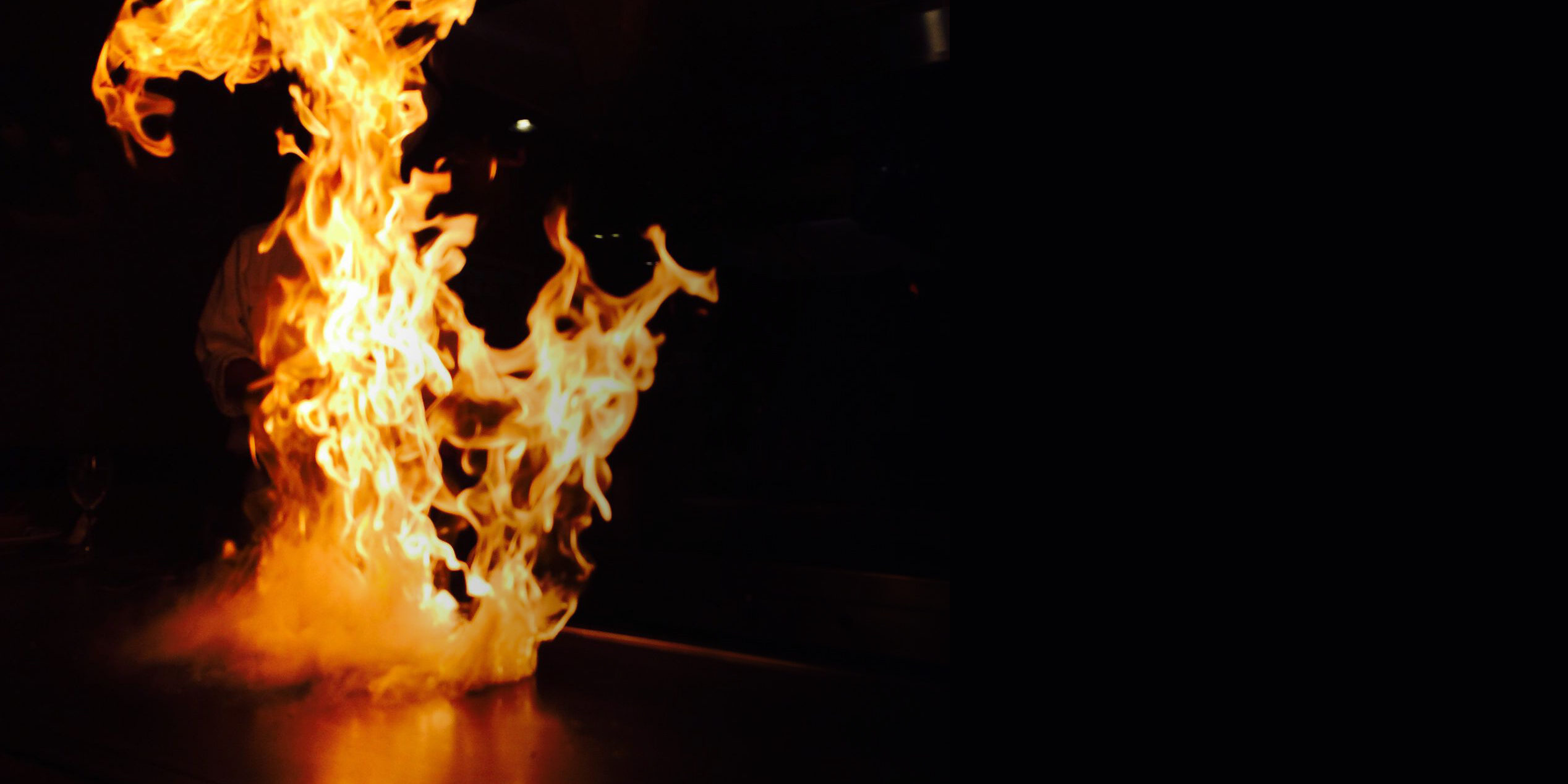 Private hibachi chef cooking with a fire display for a family gathering hibachi party in Oshawa
