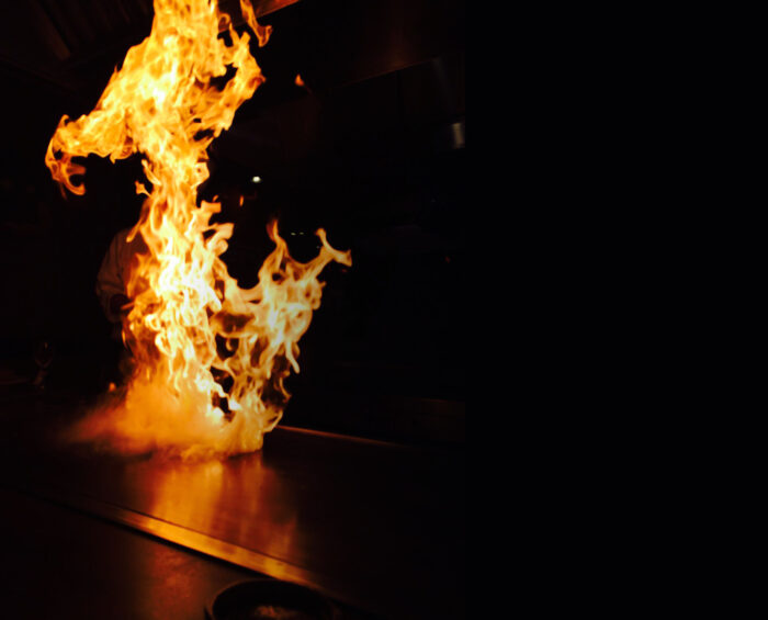 Private hibachi chef cooking with a fire display for a family gathering hibachi party in Oshawa