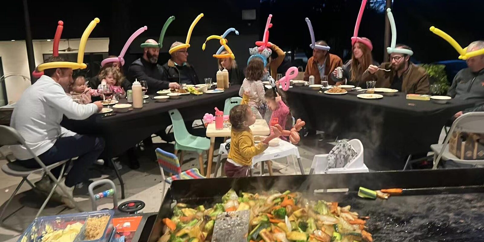 Family enjoying a backyard hibachi party in Barrie for a summer birthday celebration
