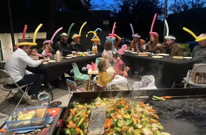 Family enjoying a backyard hibachi party in Barrie for a summer birthday celebration