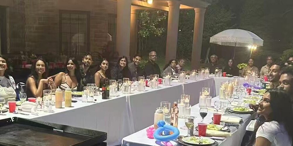 Large family enjoying a backyard hibachi dinner in Richmond Hill for a summer reunion