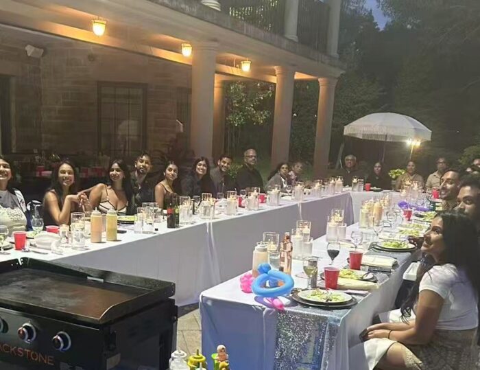 Large family enjoying a backyard hibachi dinner in Richmond Hill for a summer reunion