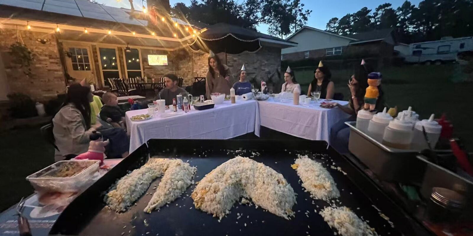 Backyard hibachi party in Toronto with family reunion guests seated around a private chef grill Backyard hibachi party in Toronto with family reunion guests seated around a private chef grill