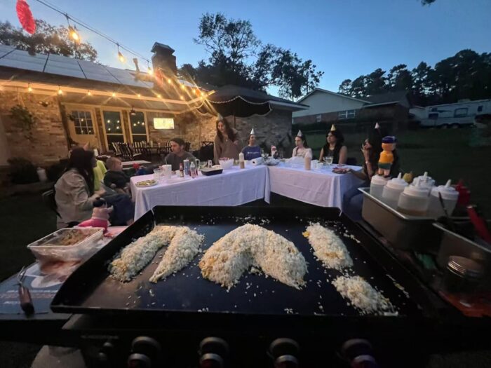 Backyard hibachi party in Toronto with family reunion guests seated around a private chef grill